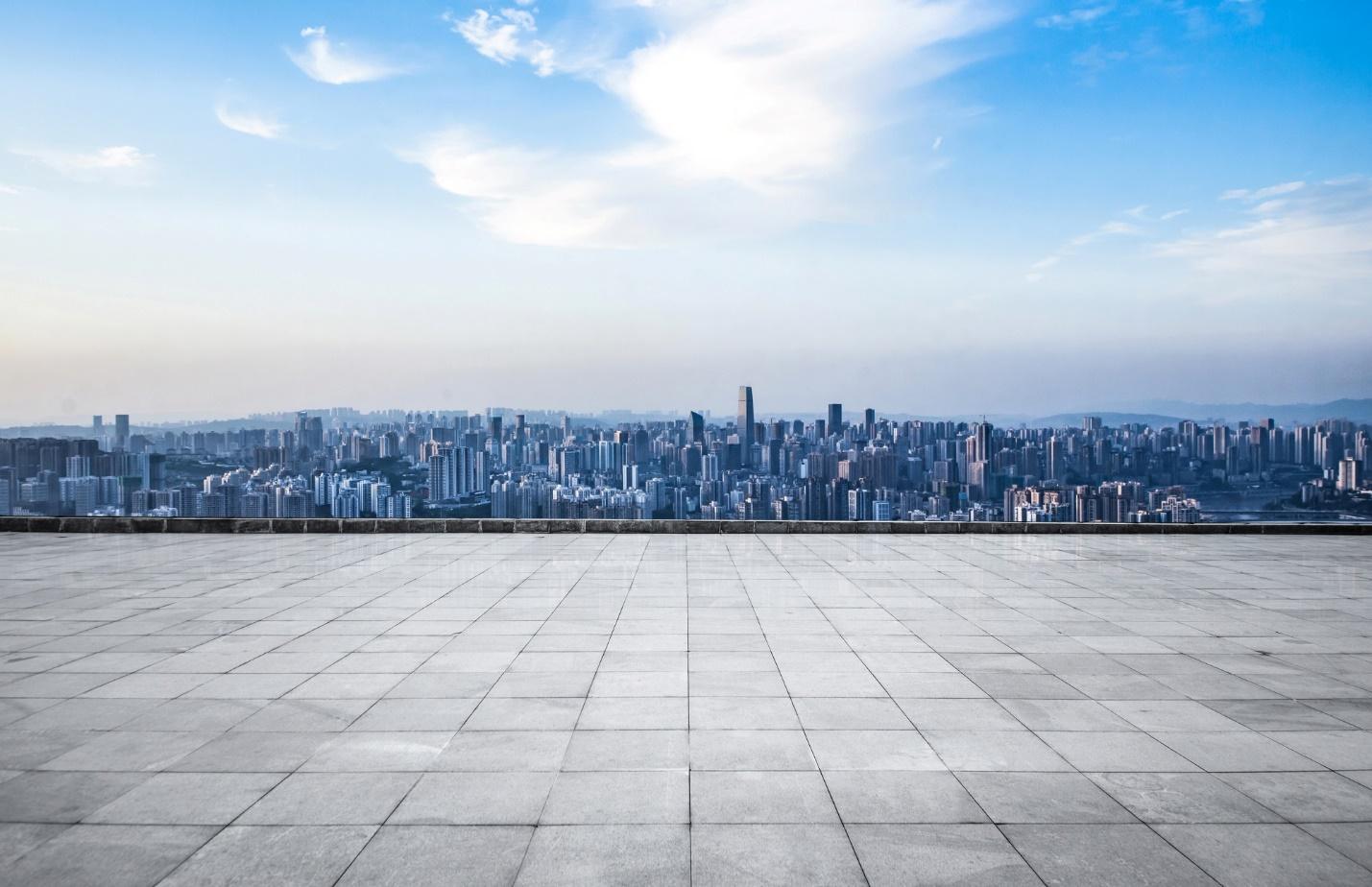 A city skyline seen from a rooftop

Description automatically generated