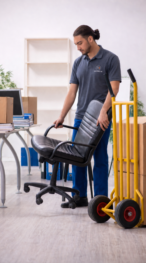 Maintenance One commercial cleaning technician preparing office workspace with professional cleaning services